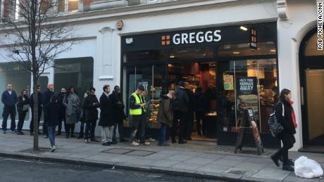 Customers queue outside a London Greggs at lunchtime.