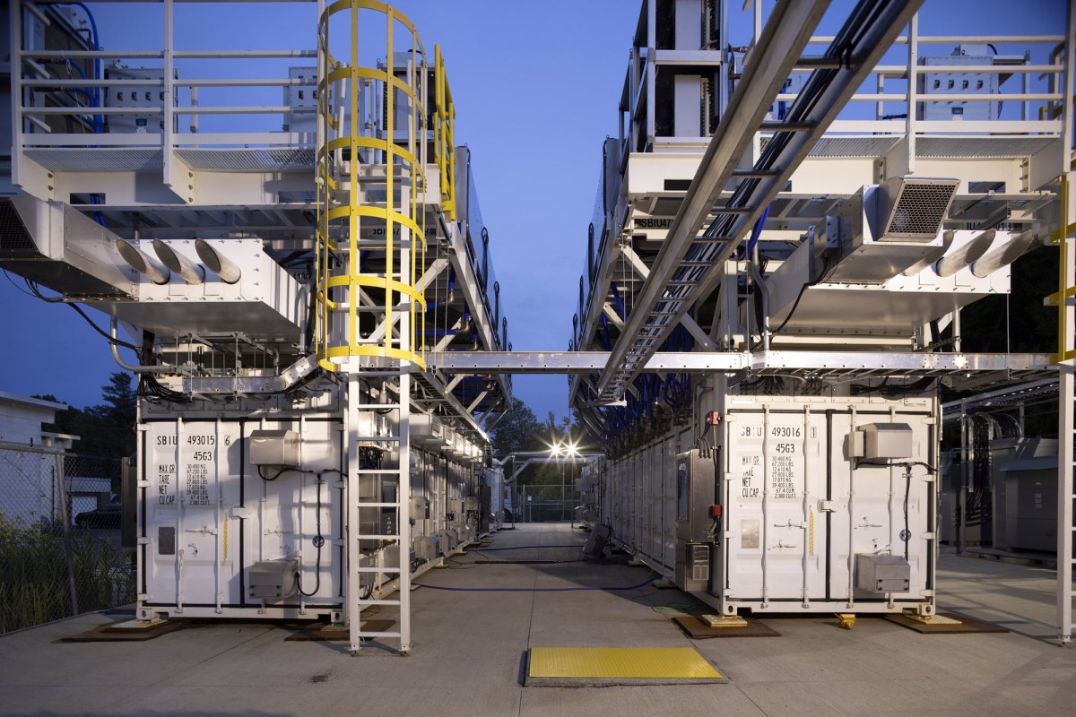 Perspective, ground-level image of the three-megawatt hydrogen fuel cell system shows a pair of 40-foot-long shipping containers, each holding 18 PEM fuel cells. A cap of radiator fans sits on top of each container.